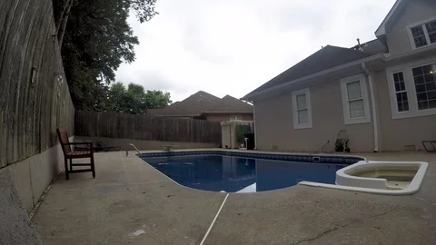 Cloud timelapse over a backyard inground swimming pool Stock Footage 95558774