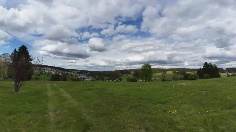Cloud Timelapse Over Green Field Under Dramatic Moving Sky Stock Footage 335371115
