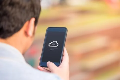 Cloud uploading concept on phone screen. Man hold phone doing cloud uploading  Stock Photos