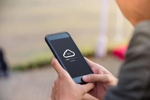 Cloud uploading concept on phone screen. Man hold phone doing cloud uploading  Stock Photos