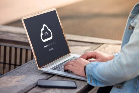 Cloud uploading concept on screen. A man is working using laptop doing cloud upl Stock Photos