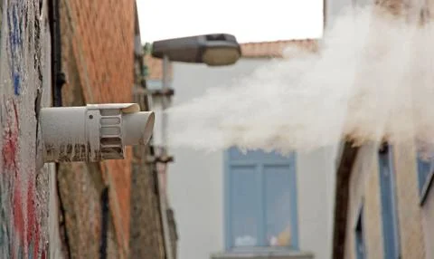 Cloud of vapor escaping from an outside pipe Stock Photos