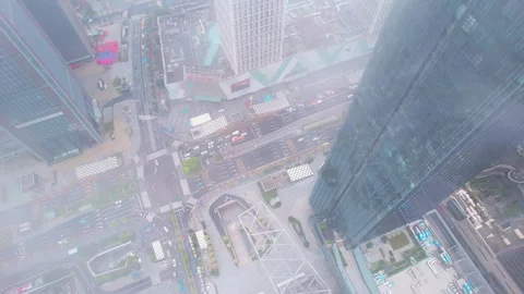 Cloud veiled city junction beside a glass tower in Guangzhou China Stock Footage 345955244