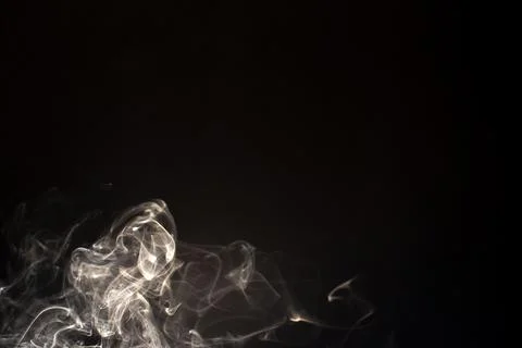 Cloud of white smoke on black background Stock Photos