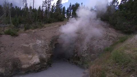 Cloud of white steam rising from opening in Yellowstone hot spring. Stock Footage 86755785
