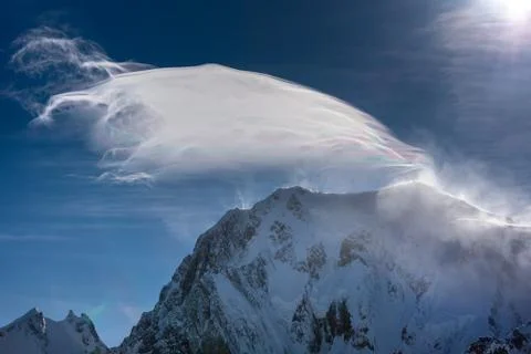 A cloud of wind blown snow over the mountain Stock Photos