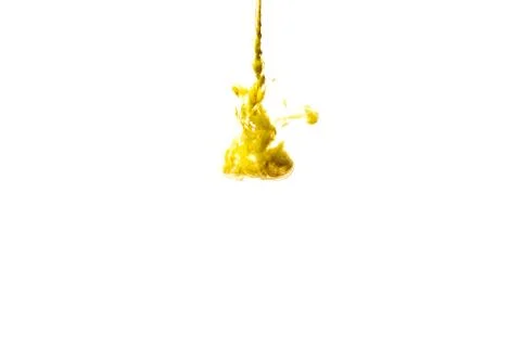 A cloud of yellow paint released into clear water. Isolate on a white backgro Stock Photos
