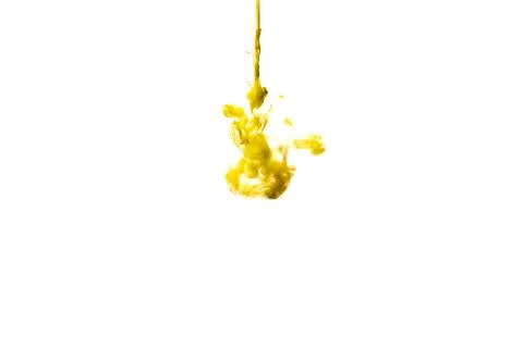 A cloud of yellow paint released into clear water. Isolate on a white backgro Stock Photos