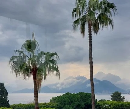 Clouded mountains and the sea Stock Photos