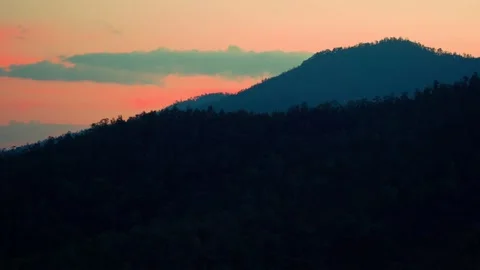 Clouded orange sky with mountain silhouette Video stock 151238623