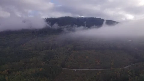 Clouded shrouded mountain tracking shot Stock Footage 253831031