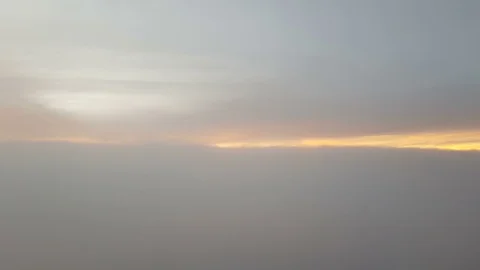 The clouded sky and sun set during a flight Видео 99378814