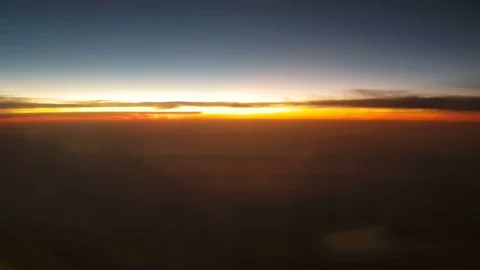 The clouded sky and sun set during a flight 库存影片 99391295