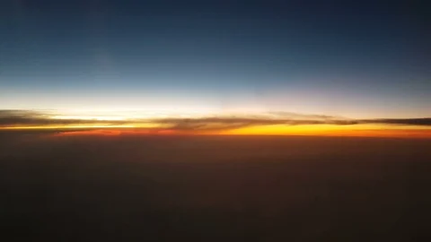 The clouded sky and sun set during a flight Видео 99391466