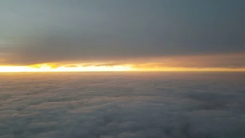 The clouded sky and sun set during a flight Stock Footage 99397048