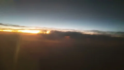 The clouded sky and sun set during a flight Видео 99397315