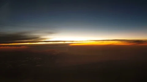 The clouded sky and sun set during a flight 库存影片 99397524