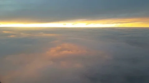 The clouded sky and sun set during a flight Видео 99398247