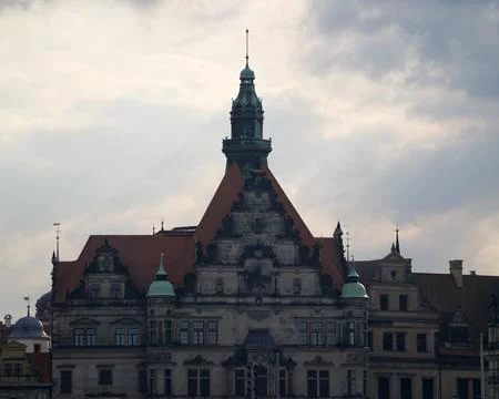 Clouded sky cast over heritage buildings featuring steep roofs and ornate a.. 写真素材