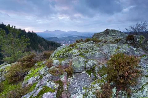 Clouded sunset on rosky mountain Stock Photos