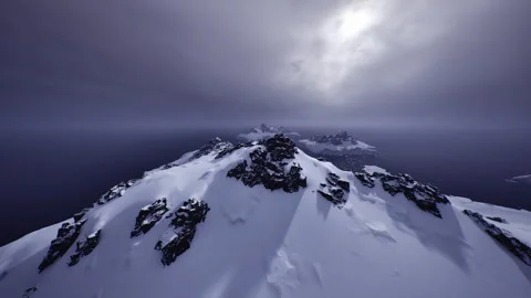 Cloudladen summit featuring fierce winds and dramatic shadows Stock Footage 330116380