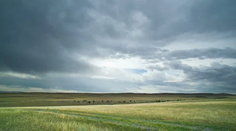 Cloudlapse over green field Stock Footage