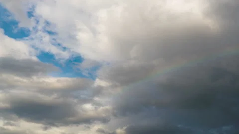 Cloudlapse with a rainbow in front of it Stock Footage 236737593