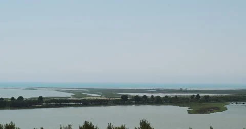 Cloudless sky, panoramic top view of green meadow with trees and calm sea. Peace 動画素材 178105141