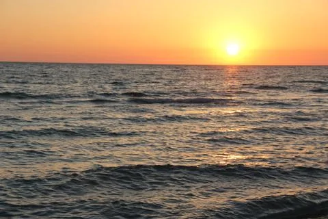 Cloudless sunset over ocean Stock Photos