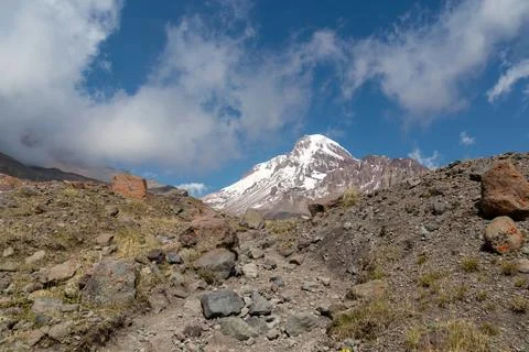 A cloudless view on Mount Kazbeg in Caucasus, Georgia. There slopes are bar.. Stock Photos