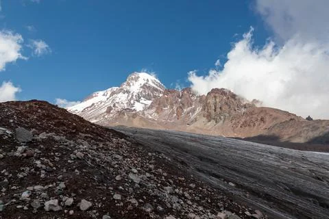 A cloudless view on Mount Kazbeg in Caucasus, Georgia. There slopes are bar.. Stock Photos