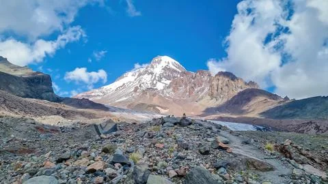 A cloudless view on Mount Kazbeg in Caucasus, Georgia. There slopes are bar.. Stock Photos
