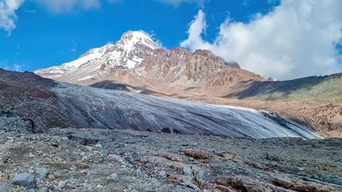 A cloudless view on Mount Kazbeg in Caucasus, Georgia. There slopes are bar.. Stock Photos