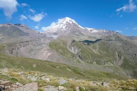 A cloudless view on Mount Kazbeg in Caucasus, Georgia. There slopes are bar.. Stock Photos