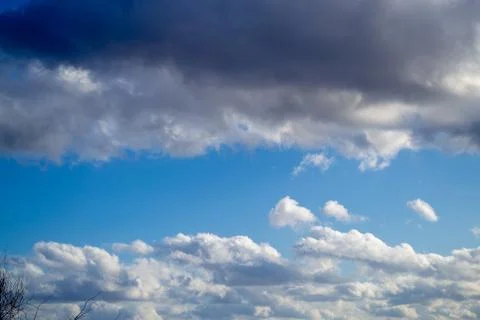 Clouds above and below and blue sky in the middle. Spring sunny day. Beautifu Stock Photos