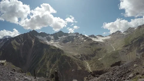 Clouds above the big snowy mountains Stock Footage 118594568