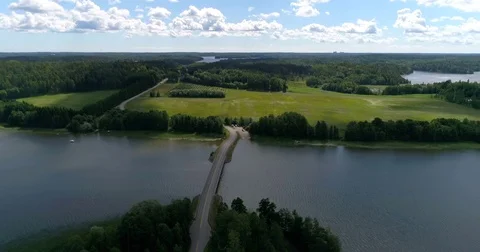 Clouds above a bridge, Cinema 4k aerial view of clouds sailing above a small bri Stock Footage 78646415