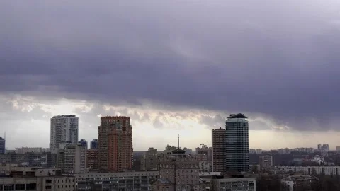 Clouds above city timelapse, windy weather at urban landscape in 4k UHD footage Video stock 146347039