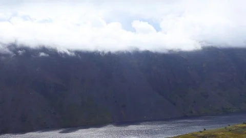 Clouds above a mountain and a lake. Stock Footage 80989658