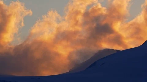 Clouds above the mountain peak at sunset timelapse Video stock 112388725