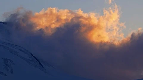 Clouds above the mountain peak at sunset timelapse Video stock 112388753