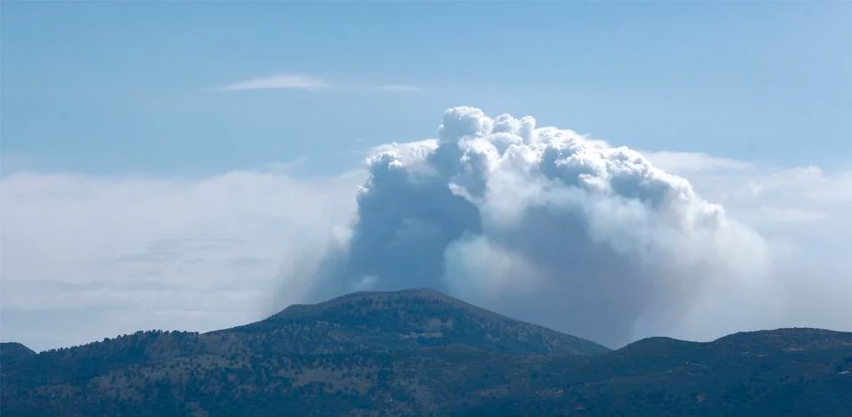 Clouds above the mountain Stock Photos