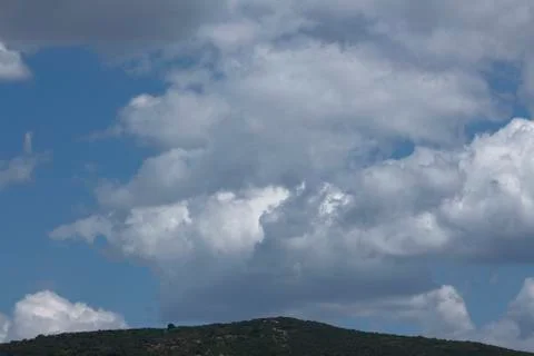 Clouds above the mountain Stock Photos
