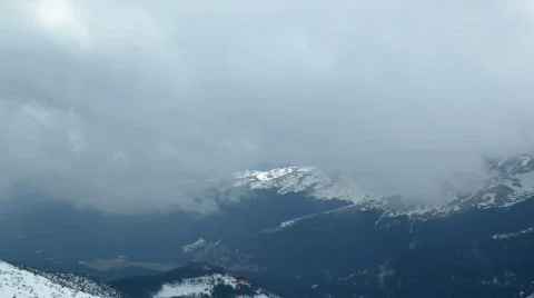 Clouds above snowy mountains,time lapse Stock Footage
