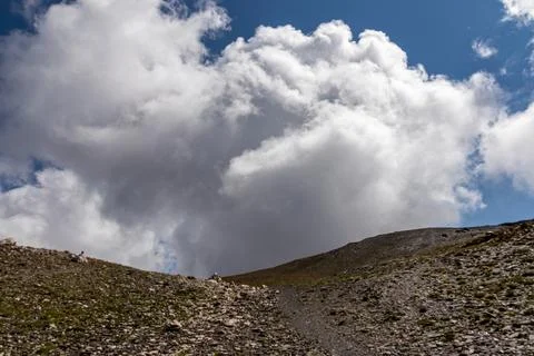Clouds accumulating around the sharp mountain peaks of the Chaukhi Pass in .. Stock Photos