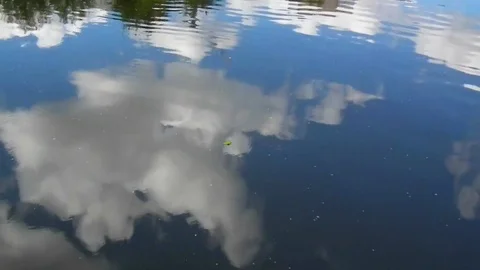 Clouds and blue sky are reflected in the water Stock Footage 92614029