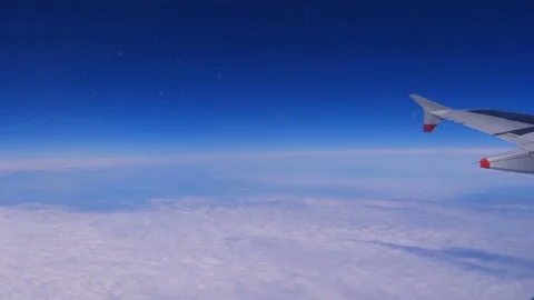 Clouds and blue sky from the plane. Traveling by air. Stock Footage 75785937