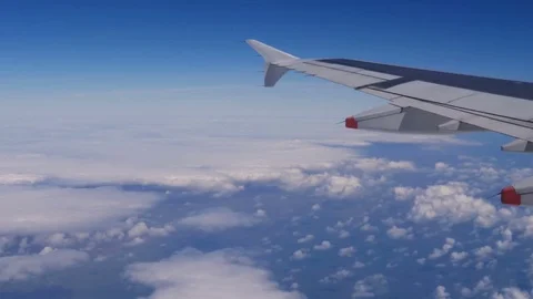 Clouds and blue sky from the plane. Traveling by air. Stock Footage 75807900