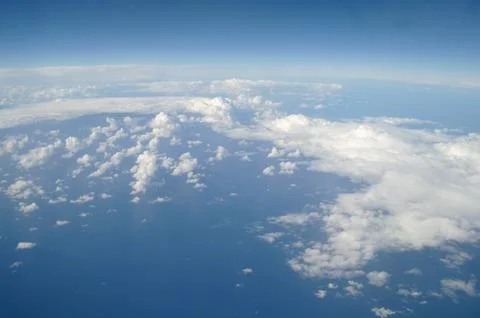 Clouds and blue sky seen from plane Stock Photos