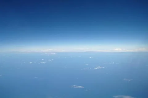 Clouds and blue sky seen from plane Stock Photos